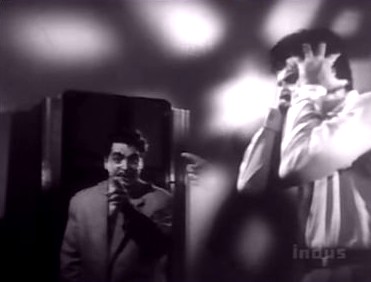 The hand in the reflection has a mirror image outside the mirror!