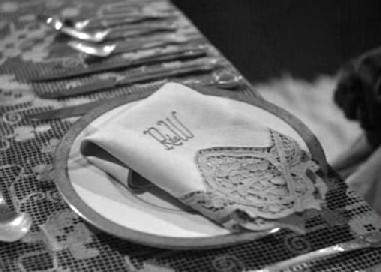 ...and finds Rebecca's napkin at the dinner table ...and finds Rebecca's napkin at the dinner table