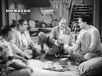 A group of businessmen have a chat with Harnam Singh