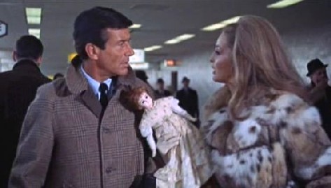 Lisa hands the doll over to a stranger