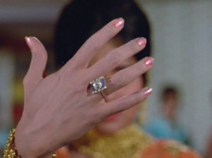 ... and Shalu brandishes her engagement ring at him