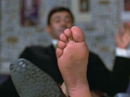 Vinay shows the assembled company his foot
