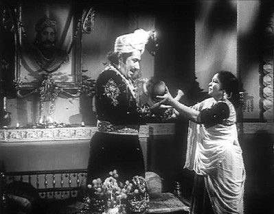 The midwife hands over the king's son to him