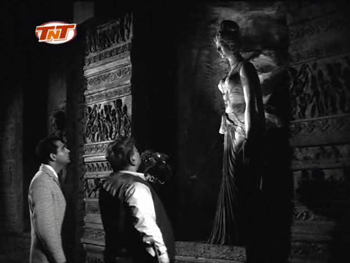 Professor Sahib and Rakesh examine an old statue