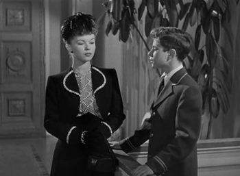 Susan arrives, passing herself off as a model...