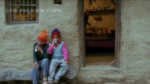 Makar and Kamru outside their home