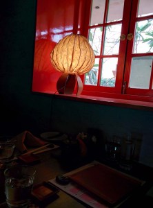 A pretty paper lantern on a windowsill.