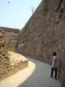 Salim guides us through Golconda, showing us water pipes slung along this high wall. 