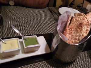 Papads with dips - a green chutney, and a mango-and-yoghurt one.