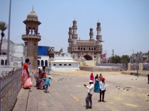 Outside the Mecca Masjid: a family gets photographed against a backdrop of the Charminar.