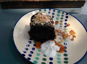 The Old Monk(ey) chocolate cake, served with whipped cream and praline.