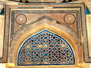 Incised plaster and tile decorate an arch inside the tomb.