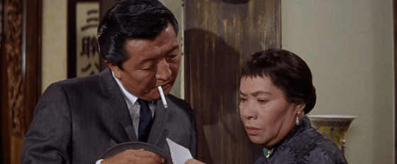 Sammy Fong passes on Mei Li's picture to Auntie Liang