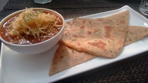 Parsi salli boti, served with paratha.