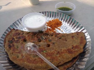 A fantastic thaalipeeth with two types of chutney and a raita.