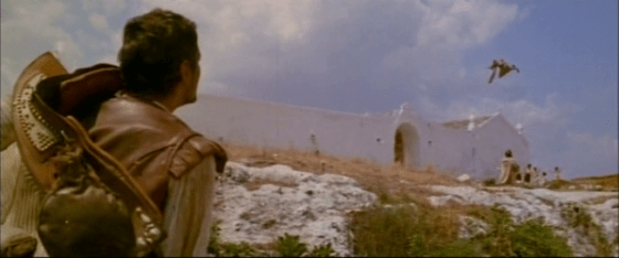 Rodrigo arrives at a monastery above which a monk flies