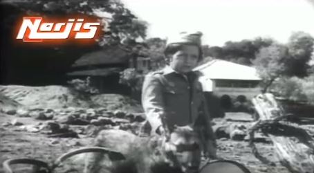 Little Raju goes to the riverbank to await the arrival of his mother