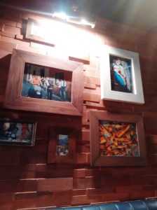 A wall at the restaurant, decorated with framed photos of Jamie, pals, Italy, etc.