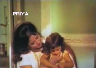 Meena coos to a little girl