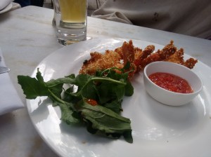 Scampi with sesame seeds, rocket, and a sweet chilli dipping sauce.