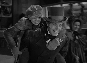 Fred gives Tiny Tim a ride