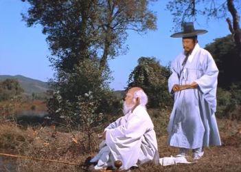 The traveller stops to talk to the Bellflower Man